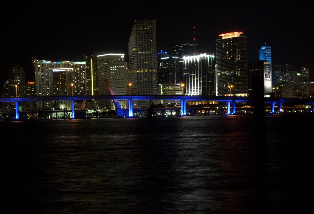 The downtown Miami skyline glowing across Biscayne Bay at night